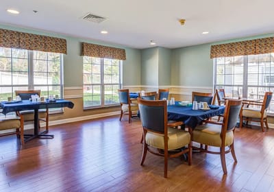 Dining area with tables and chairs overlooking garden