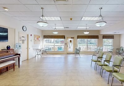 Interior view of a common area with chairs and a piano