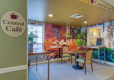 Interior view of a café area with tables and chairs