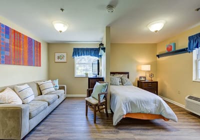 Cozy resident room with a sofa and bed