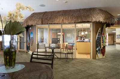 Interior view of a cafe area with tropical decor