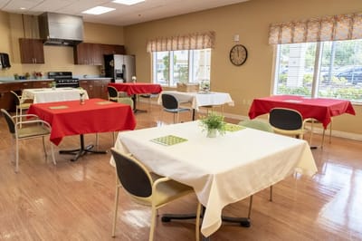 Bright dining room with tables set for meals