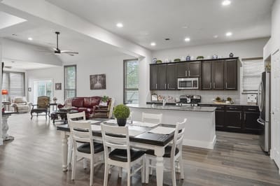 Bright, spacious common area with dining table and seating