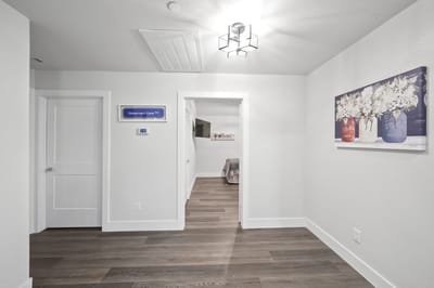 Bright corridor with floral artwork and a sign