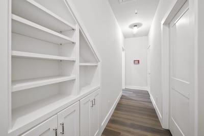 Bright hallway with shelves and doors