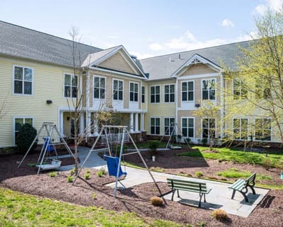 Outdoor playground area with swings and benches
