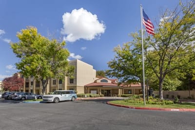 Exterior view of a senior living facility with landscaped area
