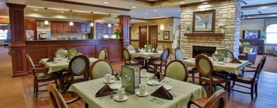 Dining area with neatly set tables and warm decor