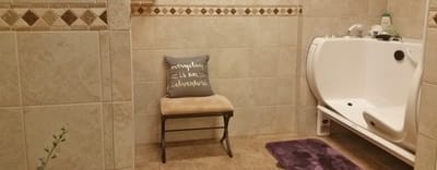 Accessible bathing area with a supportive chair