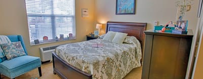 Cozy resident room with a bed and chair