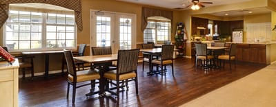 Common area with tables and chairs in the facility