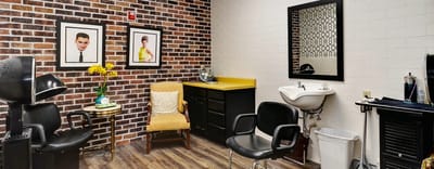 Hair salon area with stylish decor and seating
