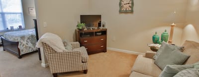 Cozy interior of a resident's room with a TV and seating