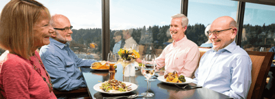 Residents enjoying a meal together in a bright dining area