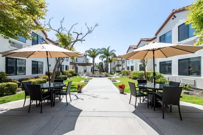 Outdoor courtyard with tables and umbrellas