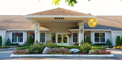 Entrance of Aegis Living Moraga with flowers and landscaping