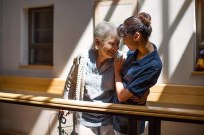 A caregiver interacting warmly with a resident