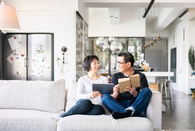 Two seniors enjoying a moment together in a cozy living room
