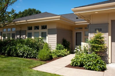 Exterior view of a senior living facility with landscaping
