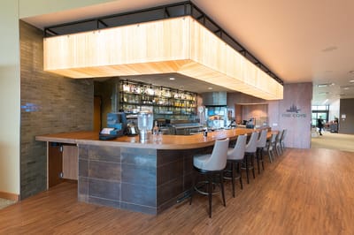 Interior view of a well-lit bar area in a senior living facility