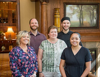 Staff members posing in a welcoming lobby area