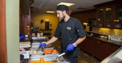 Staff serving food in the dining area