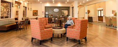 A cozy common area with seating and a resident