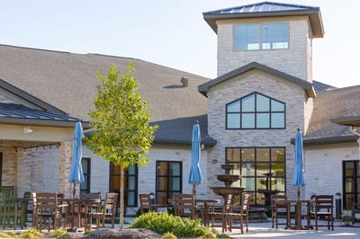 Outdoor seating area with a fountain at the facility entrance