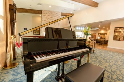 Lively common area with a grand piano and comfortable seating