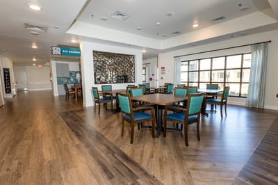 Bright dining area with wooden tables and chairs