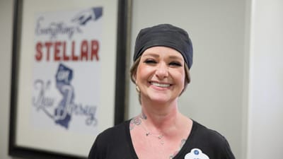 Staff member smiling in a facility interior