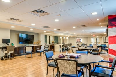 Common area in an assisted living facility with tables and chairs