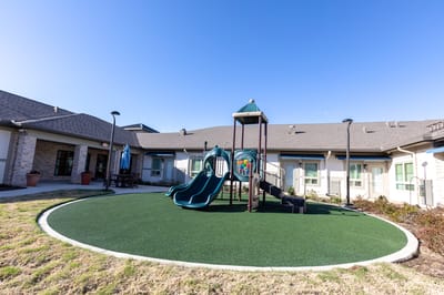Outdoor playground area with slides and play equipment
