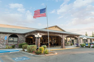Front exterior of Westgate Gardens Care Center with American flag