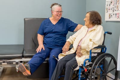 Staff member interacting with a resident in a care setting