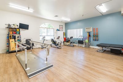 Well-equipped therapy room with exercise equipment