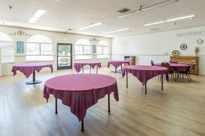 Bright common area with tables and chairs set up