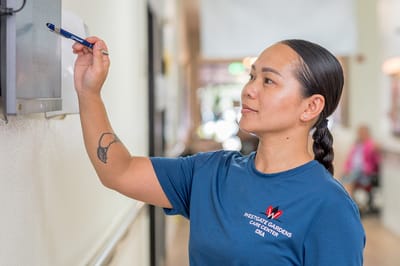 Staff member interacting in a hallway at the facility