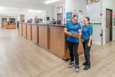Staff members discussing in the facility lobby