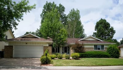 Exterior view of a single-story building surrounded by greenery