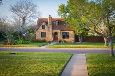Exterior view of a residential building with landscaped yard