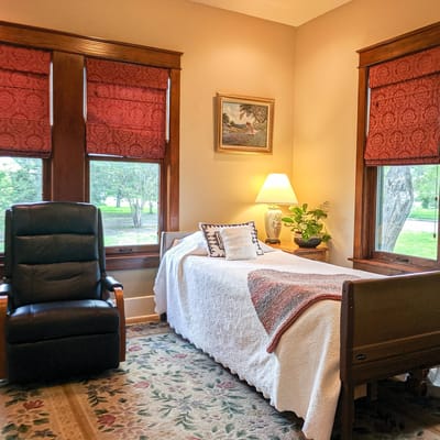 Cozy resident room with a bed and armchair