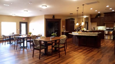 Dining area with tables and kitchen