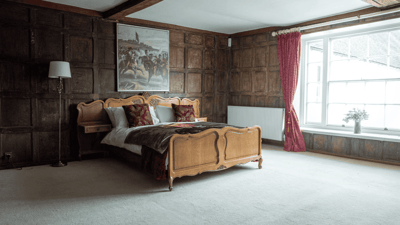 Elegant bedroom with wooden walls and a painting