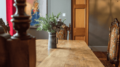 Dining area with a wooden table and decorative chairs.