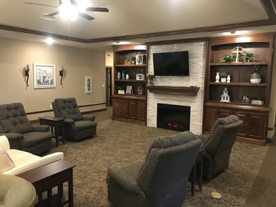 Cozy common area with chairs and shelves