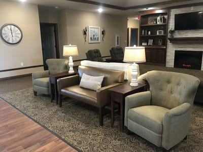 Cozy seating area with lamps and decorative features.
