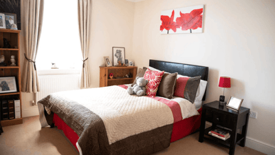 Cozy bedroom with a decorated bed and personal items.