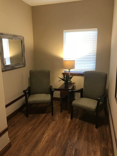 Cozy seating area with light and decor.