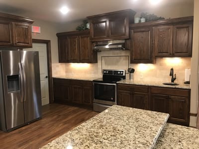 Modern kitchen with wooden cabinets and appliances.